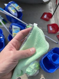 a hand holding a green rag